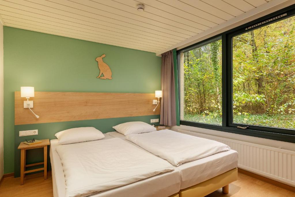 Postel nebo postele na pokoji v ubytování Center Parcs Bispinger Lüneburger Heide