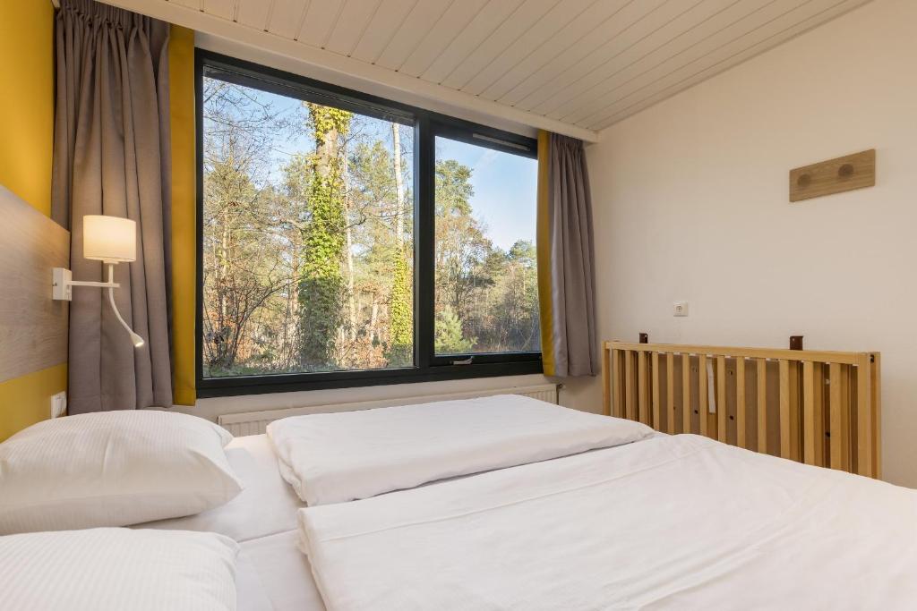 Postel nebo postele na pokoji v ubytování Center Parcs Bispinger Lüneburger Heide