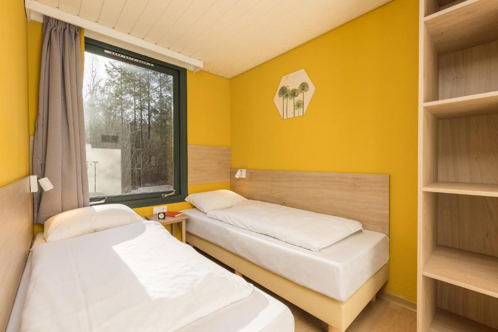 Postel nebo postele na pokoji v ubytování Center Parcs Bispinger Lüneburger Heide