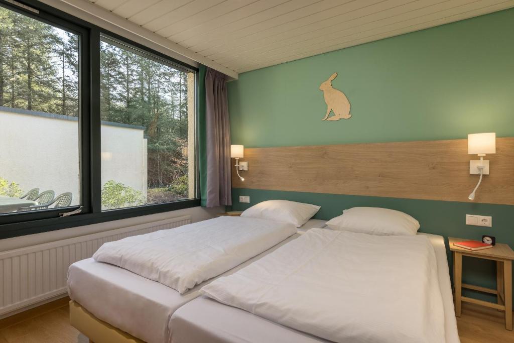 Postel nebo postele na pokoji v ubytování Center Parcs Bispinger Lüneburger Heide