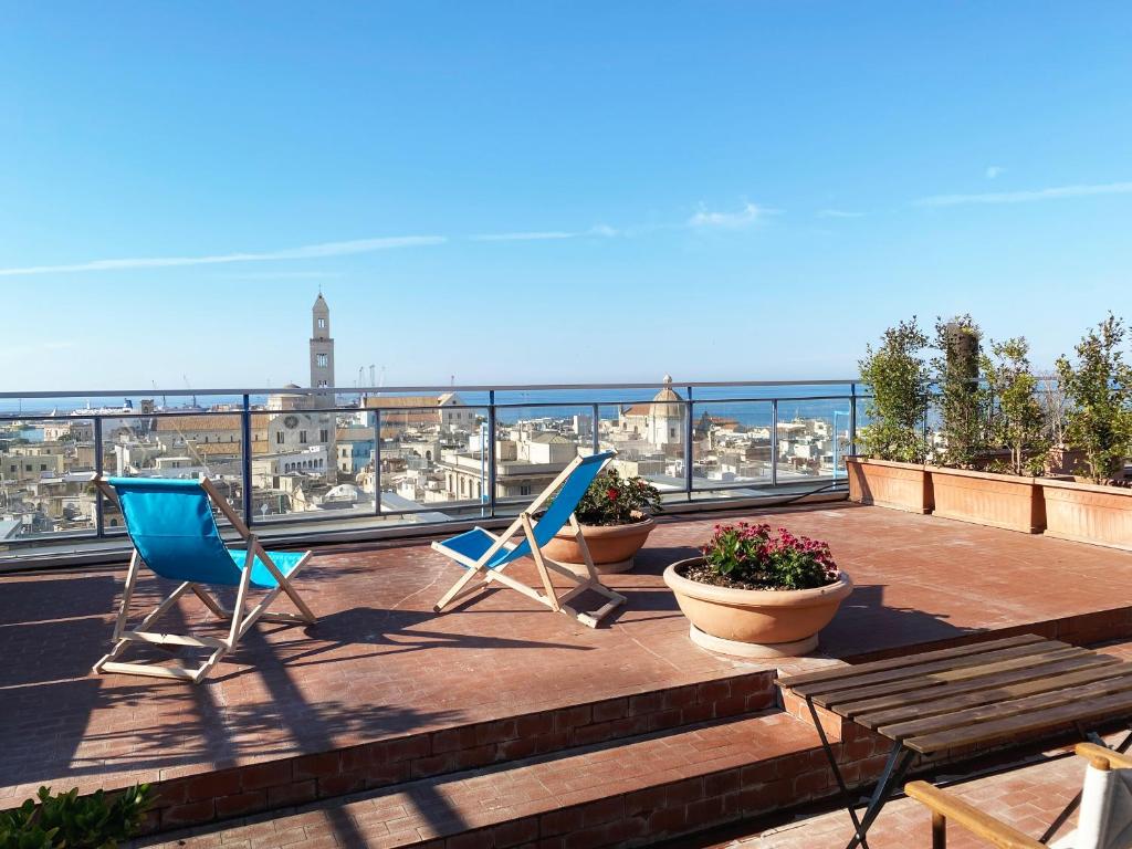 a balcony with chairs and a view of the city at Osservatorio sul mare in Bari