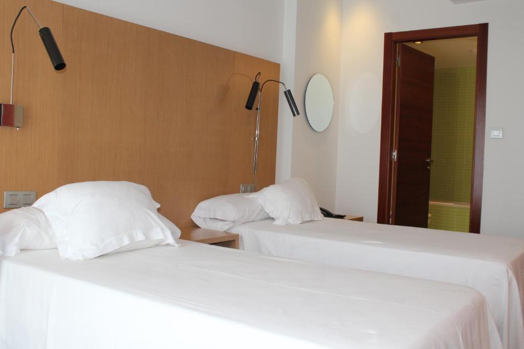 A bed or beds in a room at Hotel Ril