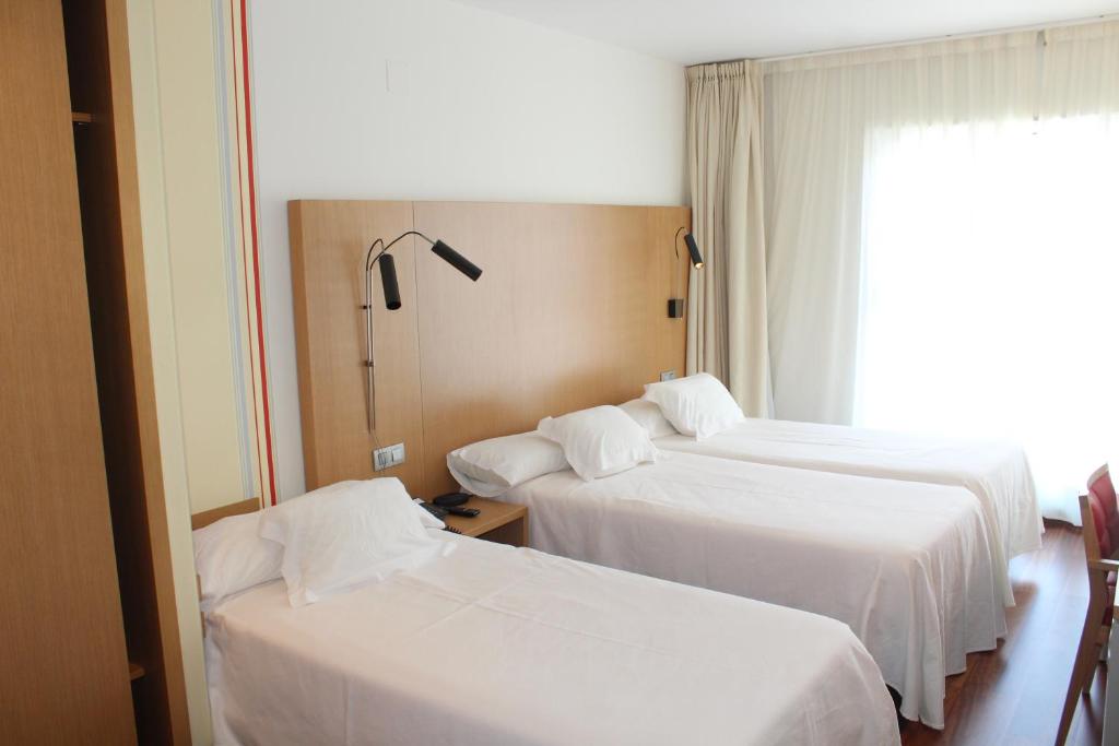 A bed or beds in a room at Hotel Ril