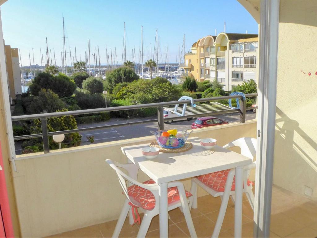 a table and chairs on a balcony with a view at Apartment Gruissan Port-2 by Interhome in Gruissan