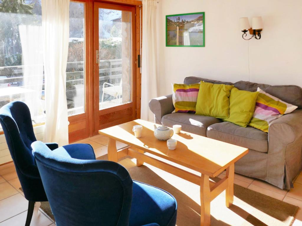 a living room with a couch and a coffee table at Apartment Muverans I B1 by Interhome in Nendaz