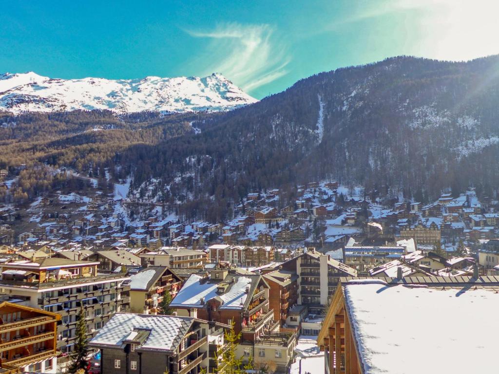 a view of a city with snow covered mountains at Apartment Milihaus A by Interhome in Zermatt