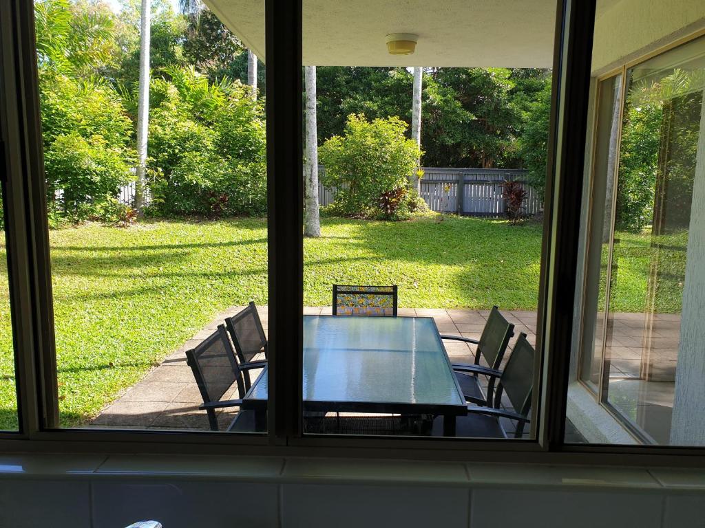 a view of a table and chairs from a window at Reef Terraces on St Crispins - Villa 2 in Port Douglas