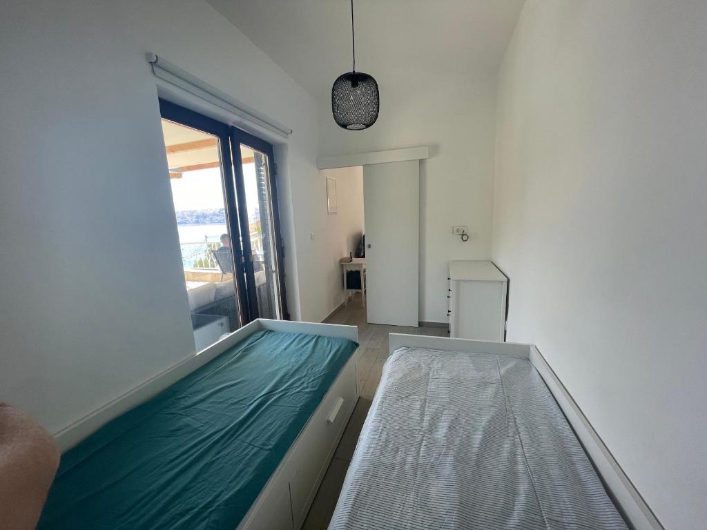 Postel nebo postele na pokoji v ubytování Apartmani Pulić