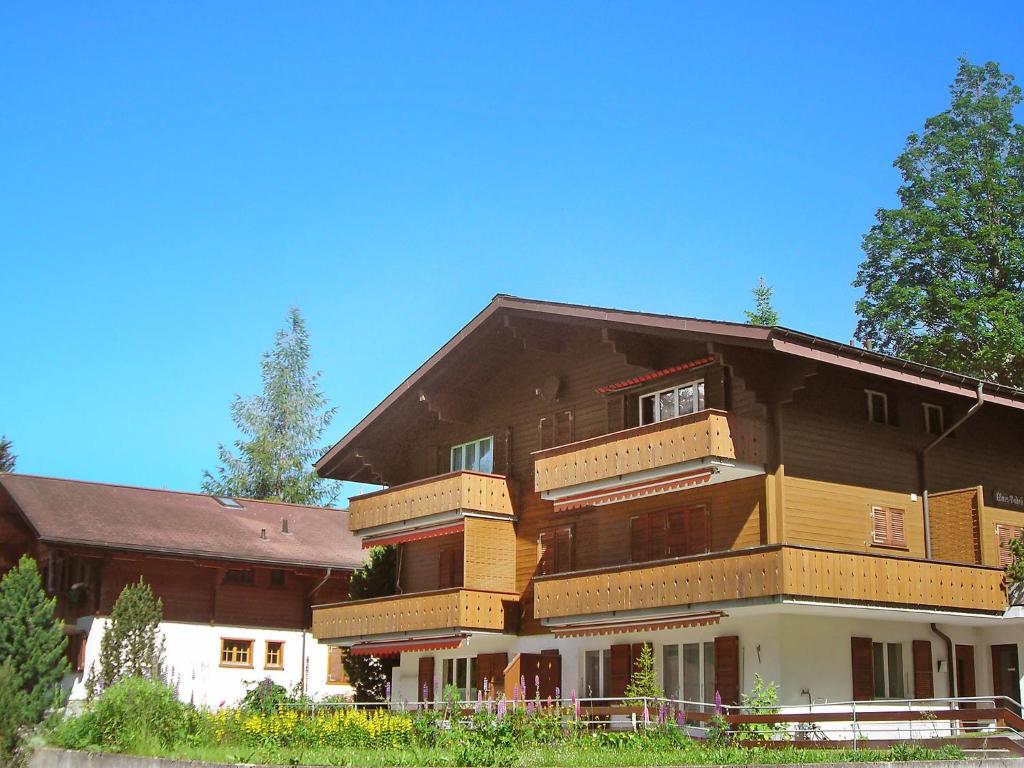 a large building with balconies on the side of it at Apartment Chalet Almis-Bödeli-1 by Interhome in Grindelwald