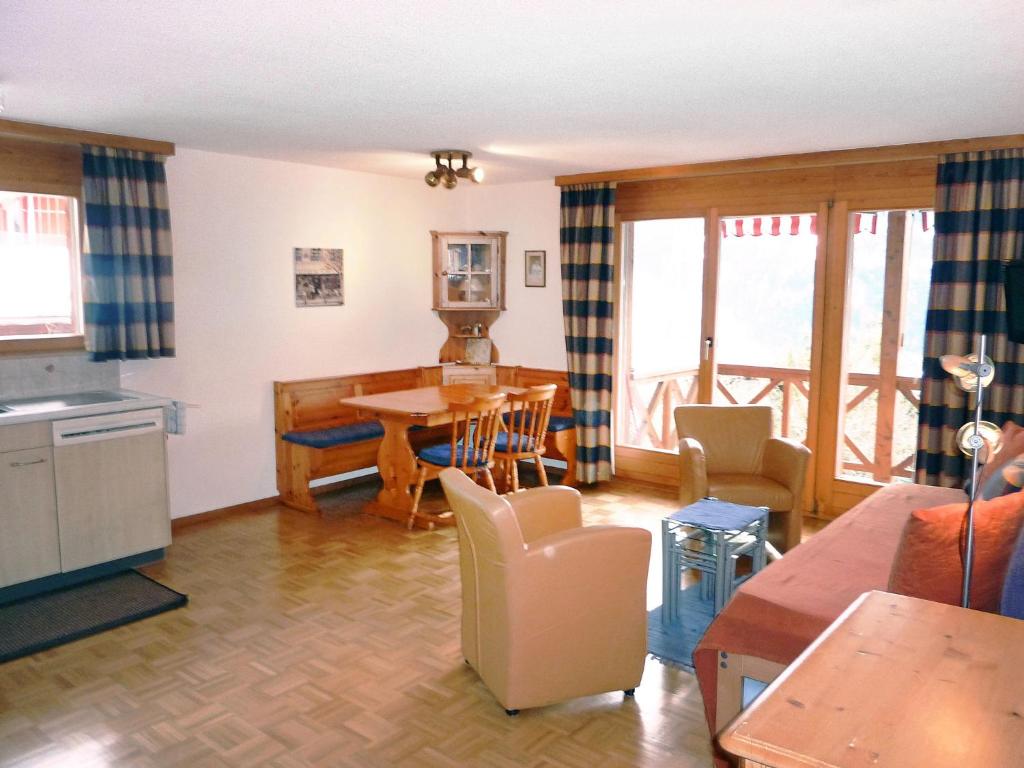 a kitchen and living room with a table and chairs at Apartment Rose Apt- Y by Interhome in Wengen