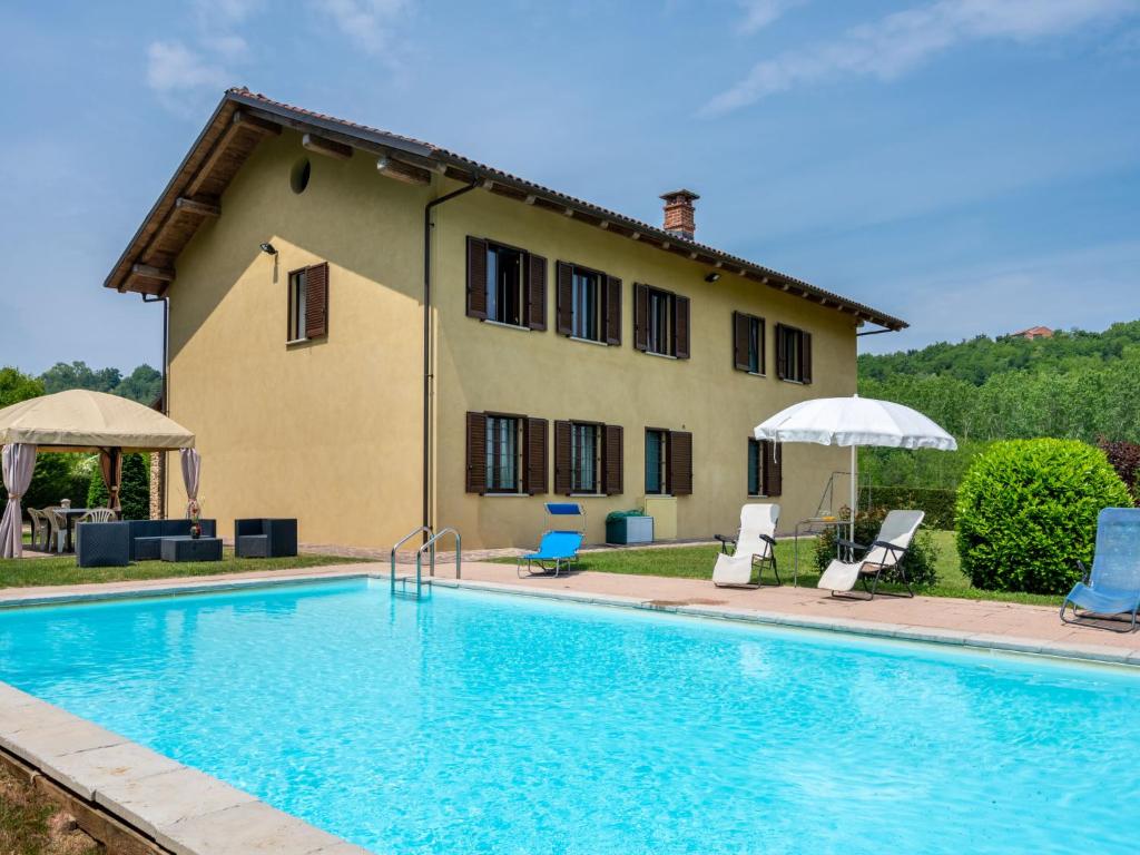 a villa with a swimming pool in front of a house at Holiday Home Casa Nocciola by Interhome in Ferrere