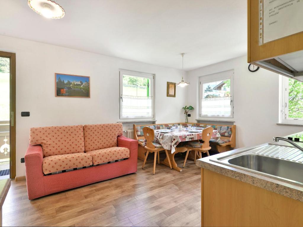 a living room with a couch and a table at Apartment Cecilia-2 by Interhome in Campitello
