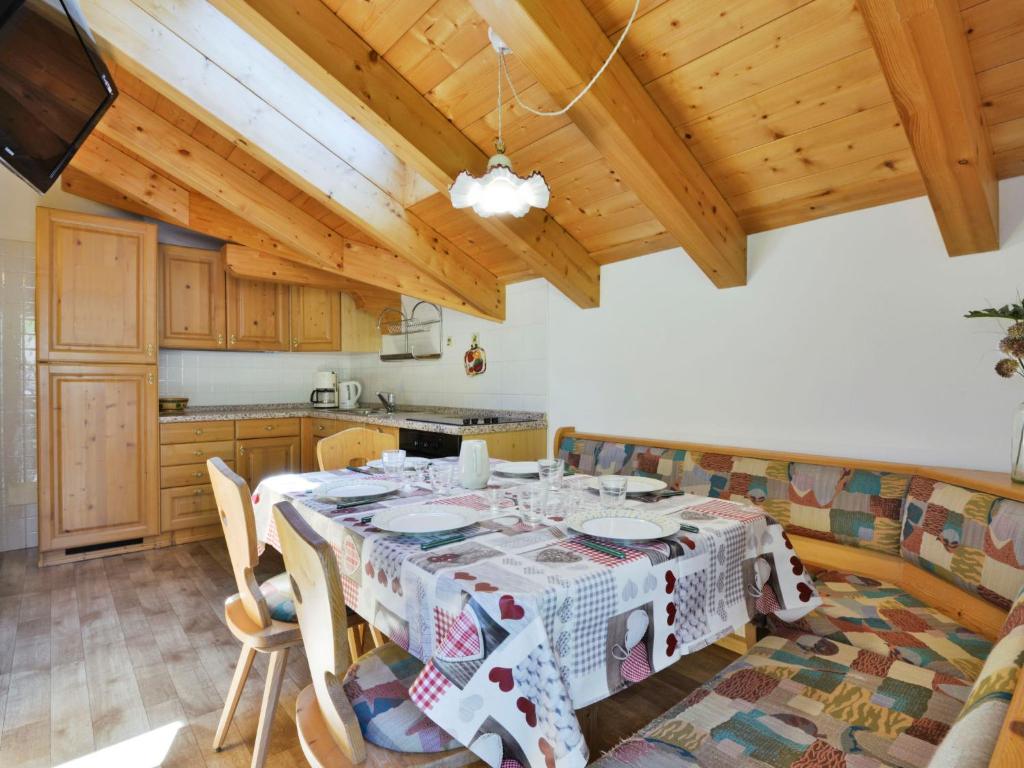 a dining room with a table and a kitchen at Apartment Cecilia-4 by Interhome in Campitello