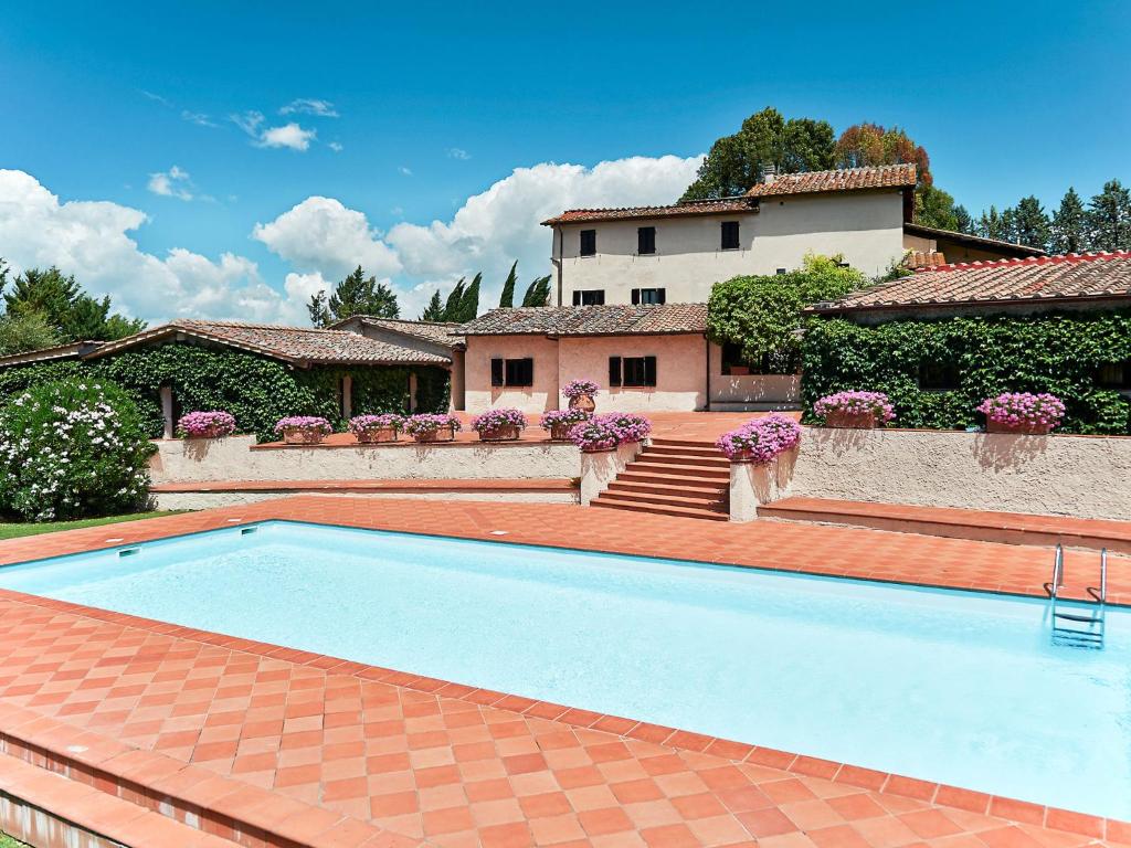 a swimming pool in front of a house at Apartment Bardeggiano - Caterina 1 by Interhome in Belvedere