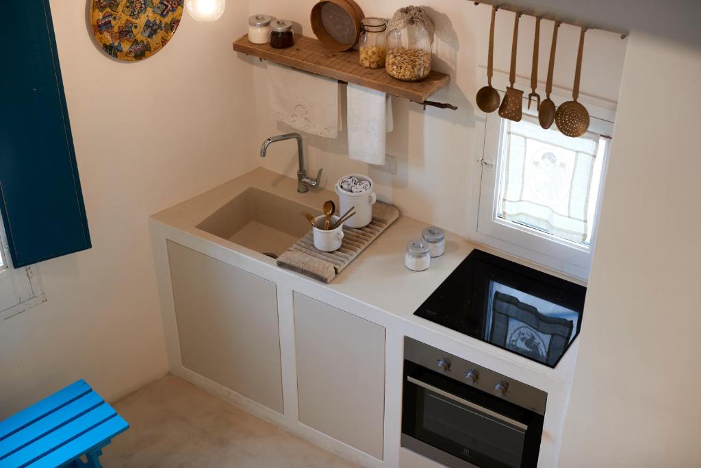 a small kitchen with a sink and a window at Dei Serafini in Polignano a Mare