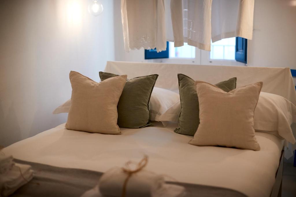 a white bed with pillows on top of it at Dei Serafini in Polignano a Mare