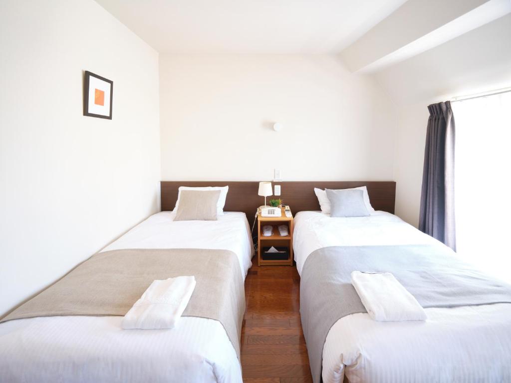 Postel nebo postele na pokoji v ubytování Pod Select Hotel Shinjuku
