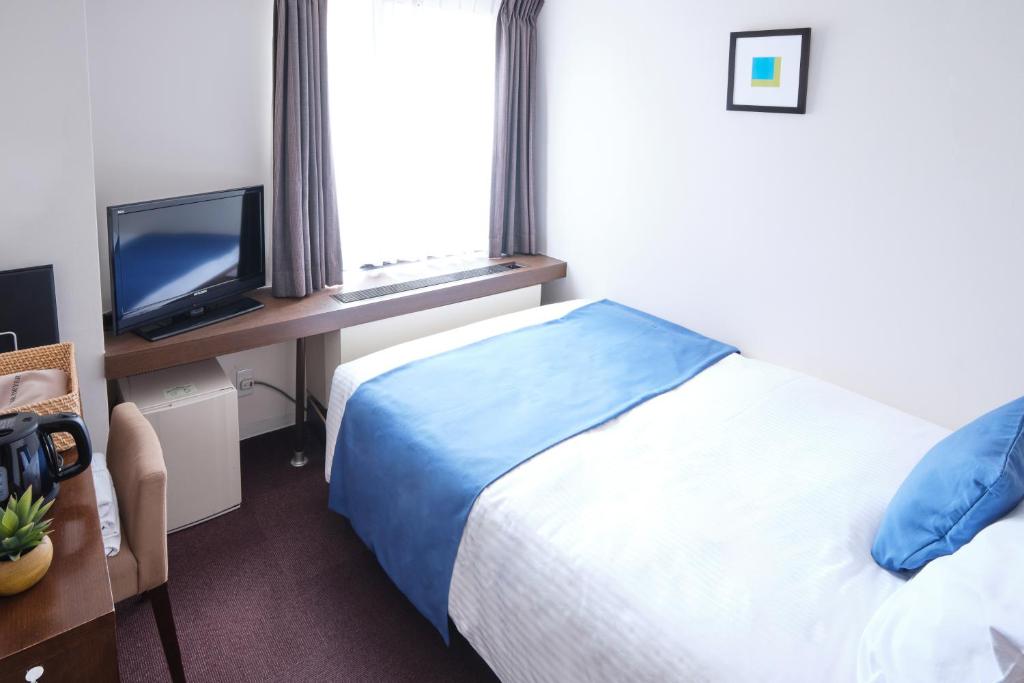 Postel nebo postele na pokoji v ubytování Pod Select Hotel Shinjuku