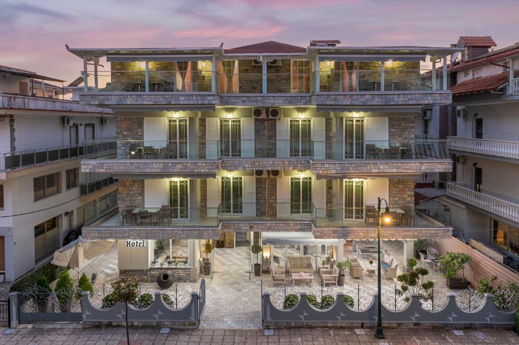 an aerial view of a building at dusk at Ouzas luxury Hotel in Olympic Beach