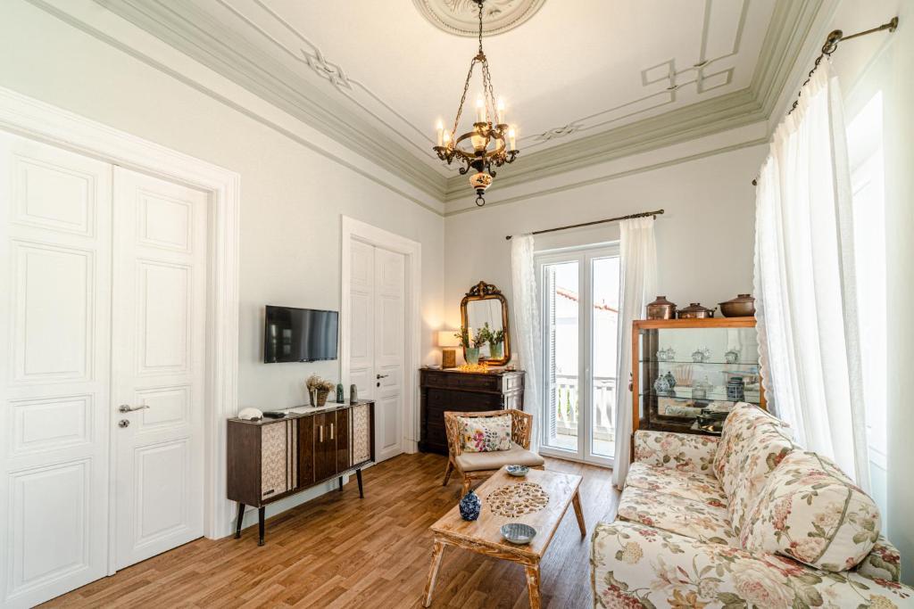 a living room with a couch and a table at Castel Abaso Boutique Apartments in Andros