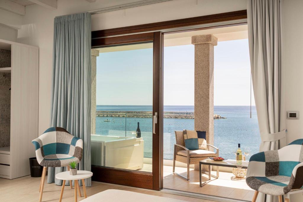 a living room with a view of the ocean at Hotel Ristorante La Conchiglia in Cala Gonone