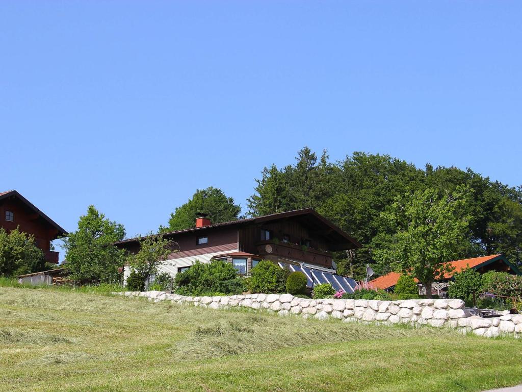 ein Haus auf einem Hügel mit einer Steinmauer in der Unterkunft Apartment Eisele by Interhome in Kirchberg bei Mattighofen