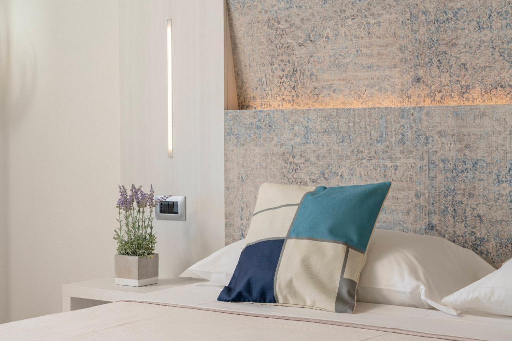 a bedroom with a bed with a wall at Hotel Ristorante La Conchiglia in Cala Gonone