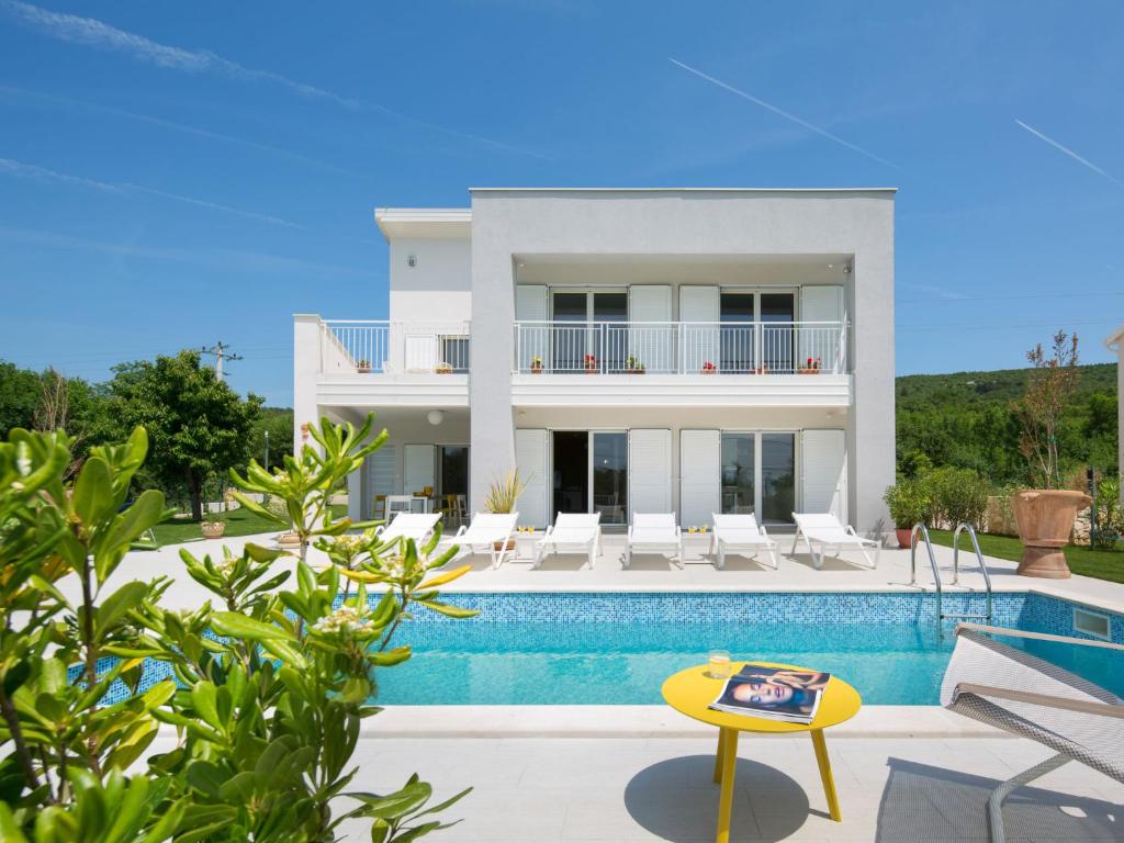 a villa with a swimming pool and a house at Villa Debora by Interhome in Diminići