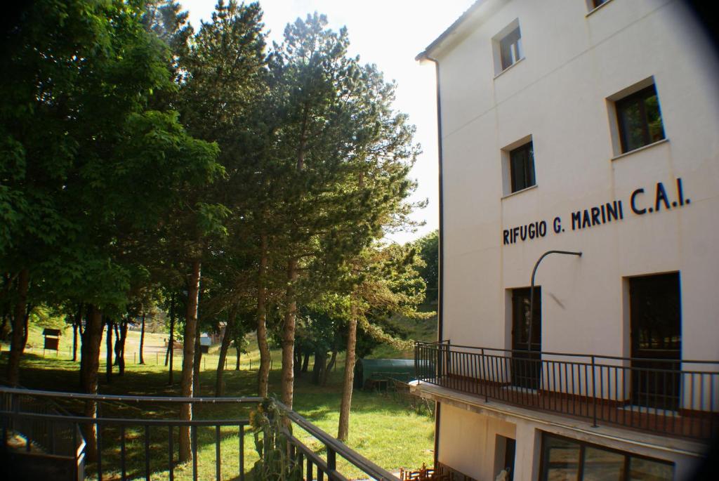 a building with a sign on the side of it at Rifugio Giuliano Marini in Piano Battaglia