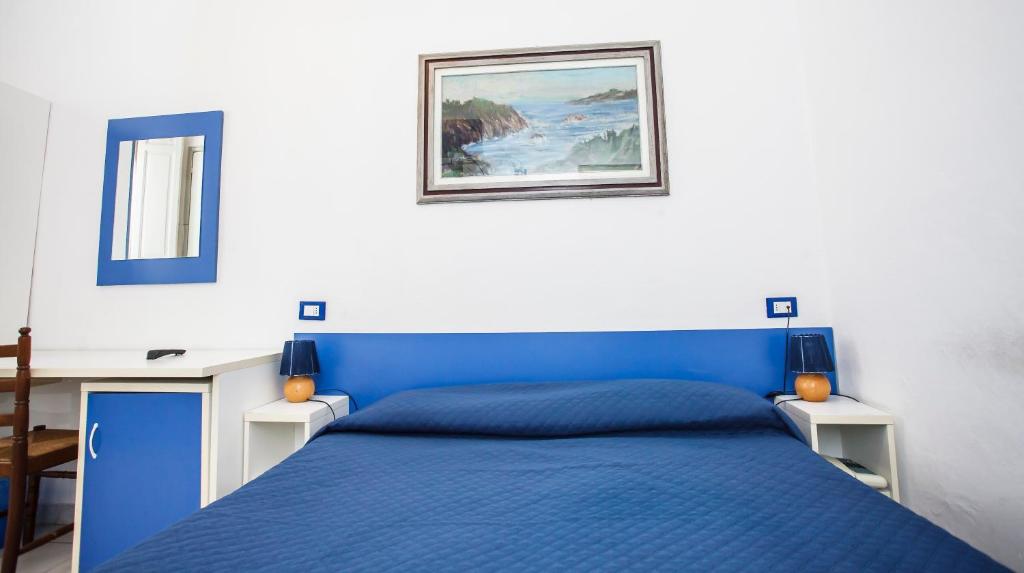 Postel nebo postele na pokoji v ubytování Hotel Rex