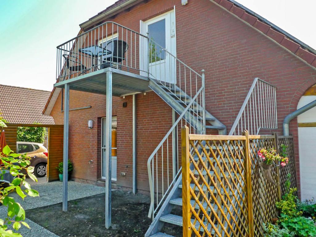 a metal staircase on the side of a house at Apartment Dori by Interhome in Westerholt