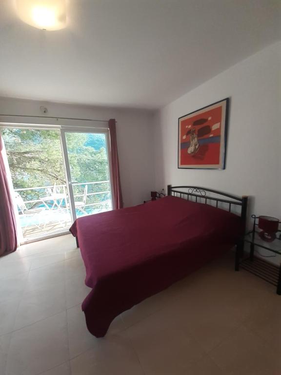 1 dormitorio con cama y ventana grande en Apartment Nikki, en Maranovići