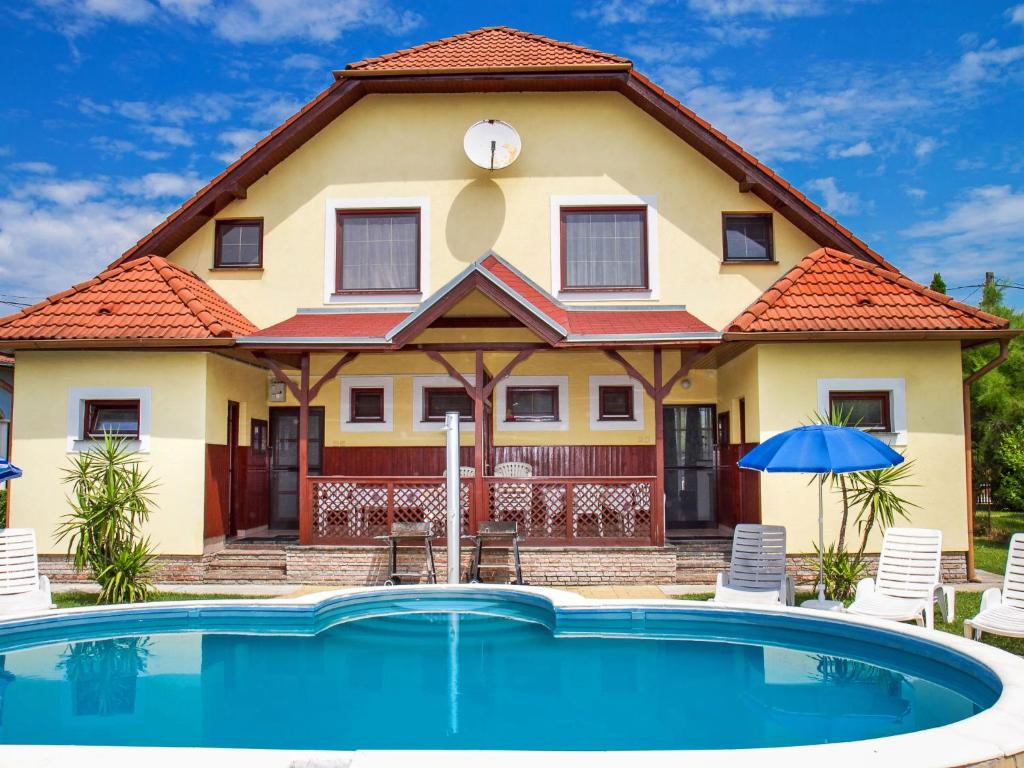 a house with a pool in front of it at Holiday Home Yellow 2 by Interhome in Balatonmáriafürdő