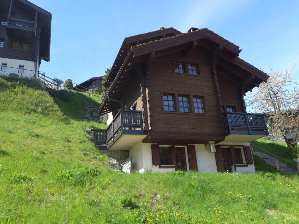 a wooden house on top of a hill at Chalet Chalet A Coeur by Interhome in Grimentz