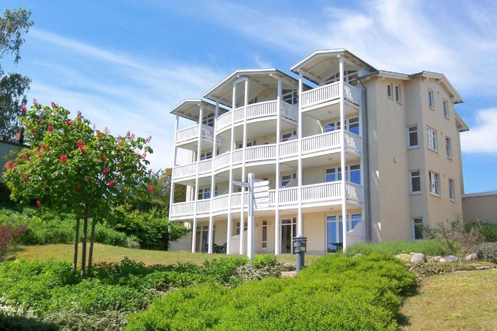 a large white building with balconies on top of it at Terrasse, gratis Nutzung vom AHOI Erlebnisbad und Sauna - Meeresblick FeWo 10 in Göhren