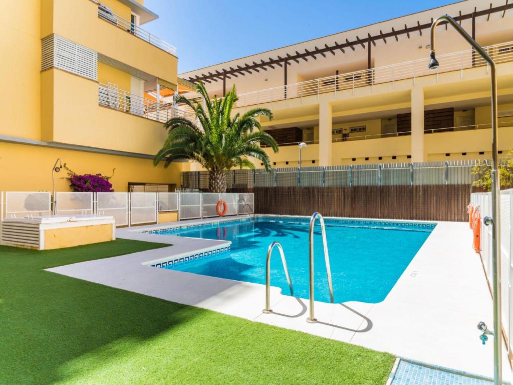 a swimming pool in front of a building at Apartment Carnaval by Interhome in Isla Cristina