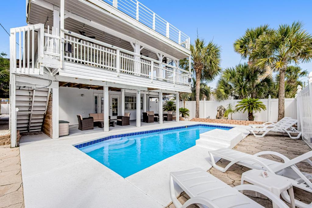 a villa with a swimming pool and a balcony at Sunshine's Holiday in Panama City Beach