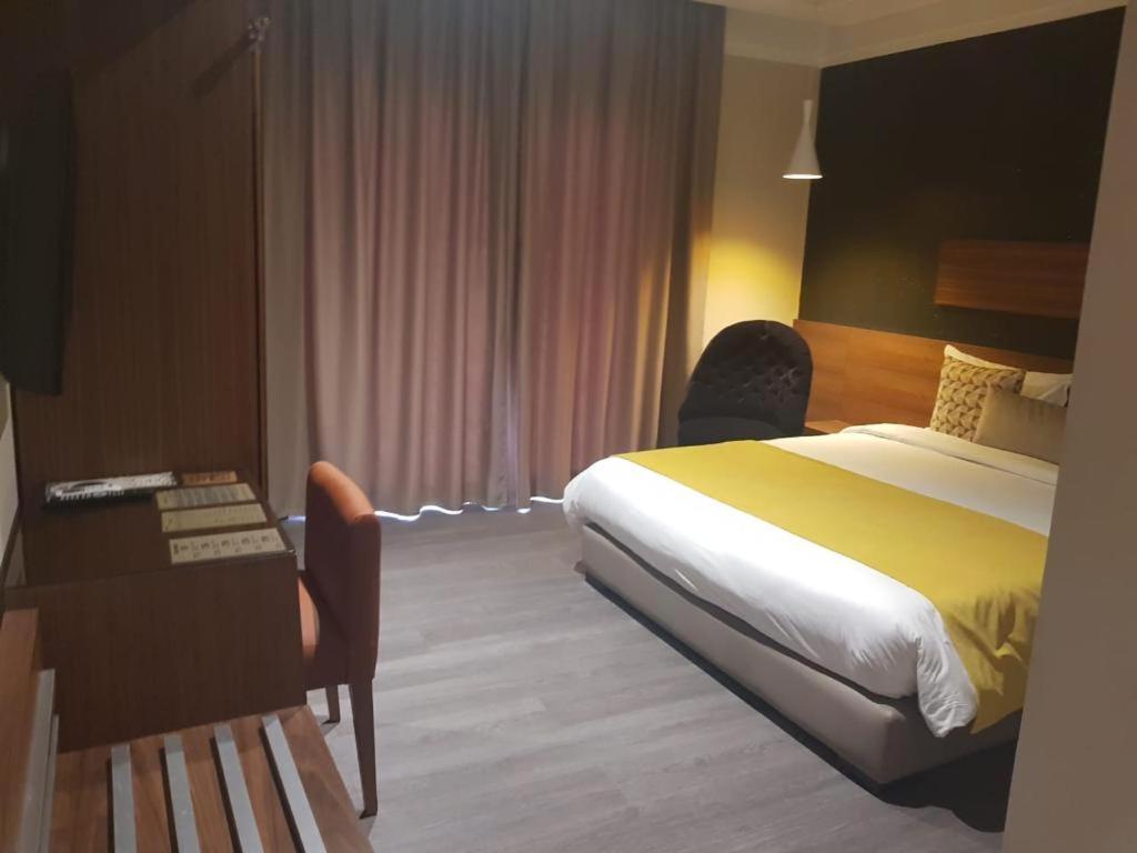 
Кровать или кровати в номере Yto boutique Hotel
