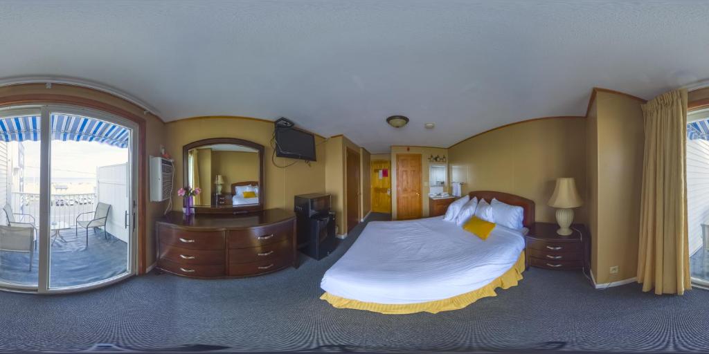 a hotel room with a bed and a large window at The Moulton Hotel in Hampton