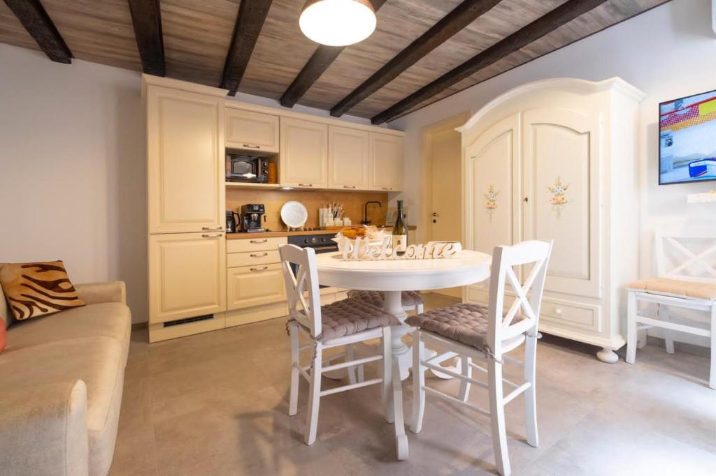 a kitchen with a table and chairs in a room at Vanilla in Izola