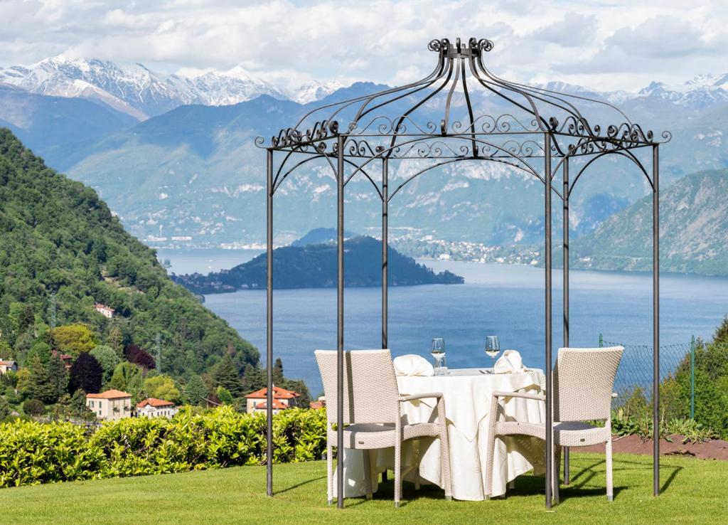 a table and chairs under a gazebo with a view at Locanda Sant' Anna in Argegno