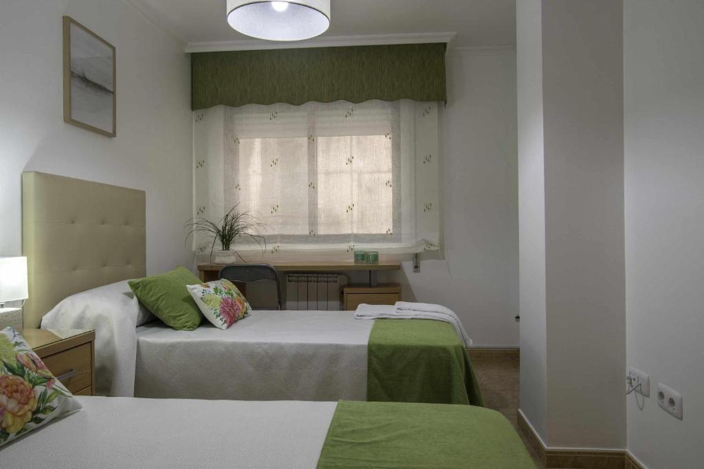 Posteľ alebo postele v izbe v ubytovaní Apartamento en Raxó