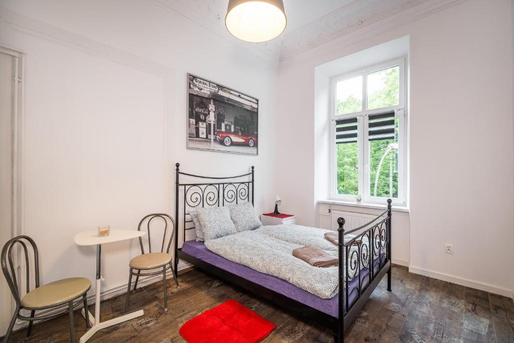 a bedroom with a bed and a table and chairs at Krakus in Kraków