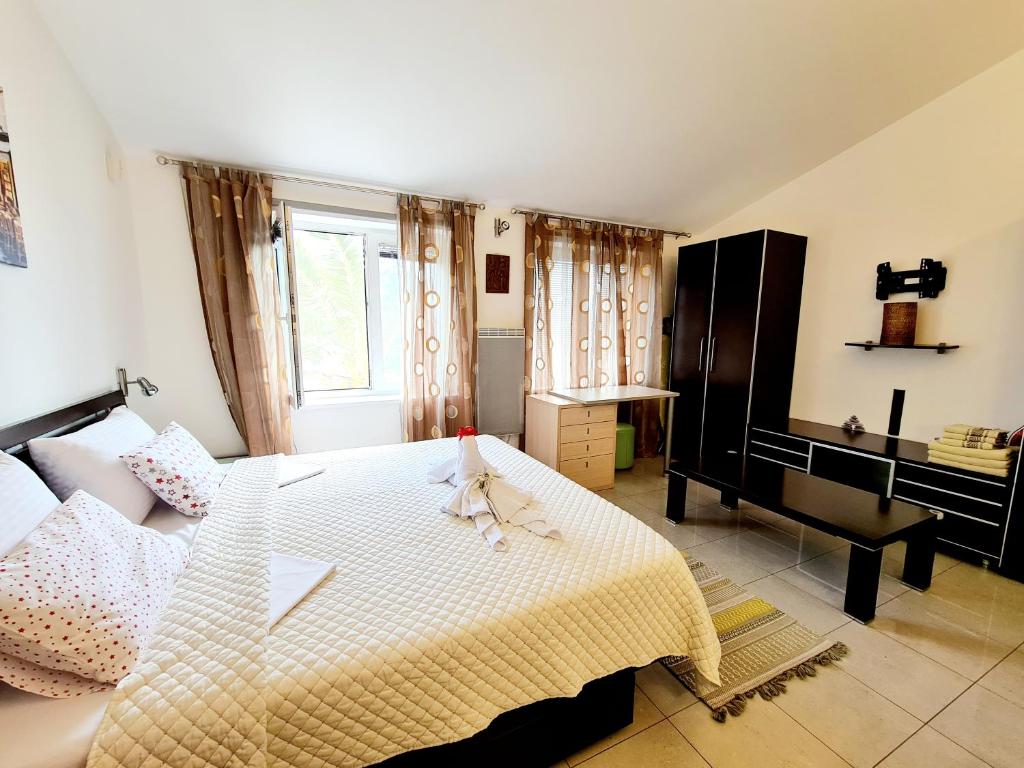 Postel nebo postele na pokoji v ubytování Olive Garden Apartment