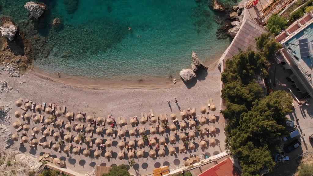 an aerial view of a beach with chairs and umbrellas at Inn Hotel in Vlorë