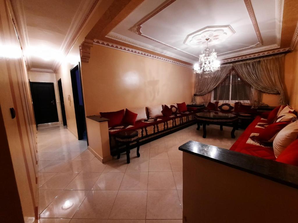 a large living room with couches and a table at Appartement Tanger in Tangier