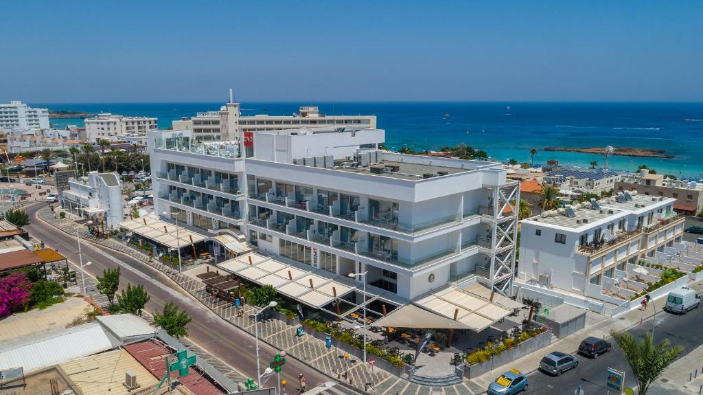 an overhead view of a large white building on a city street at Protaras Plaza Hotel in Protaras