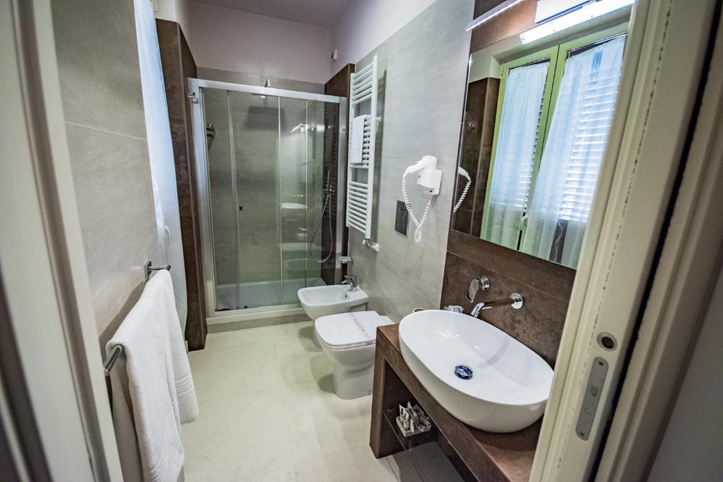 a bathroom with a sink and a toilet and a shower at Sogno D'Epoca 1822 in Monopoli