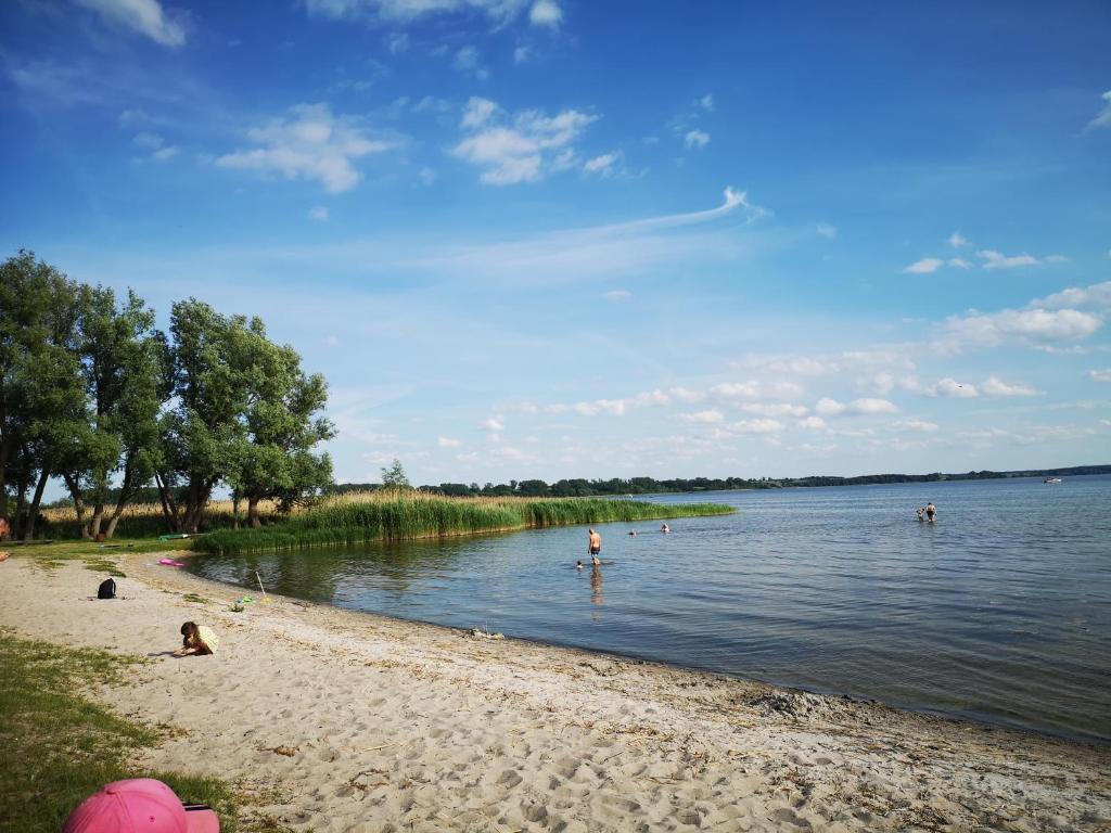 a beach with people swimming in the water at Sommerhaus Verchen in Verchen