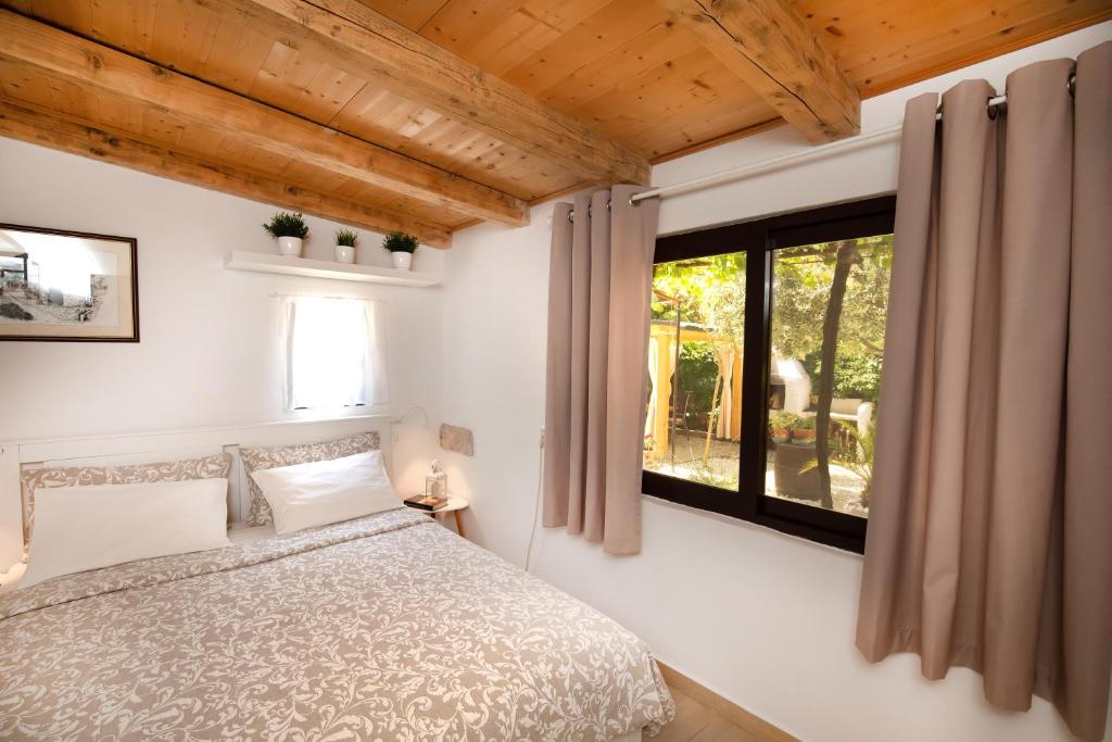 a bedroom with a bed and a large window at Apartments Mario in Pula